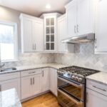 Kitchen remodel with white cabinets, quartz countertops and modern finishes