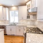Kitchen remodel with white cabinets, quartz countertops and modern finishes
