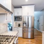 Kitchen remodel with white cabinets, quartz countertops and modern finishes