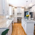 Kitchen remodel with white cabinets, quartz countertops and modern finishes