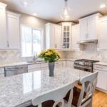 Kitchen remodel with white cabinets, quartz countertops and modern finishes