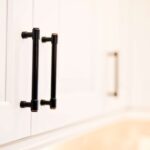 Kitchen remodel with white cabinets, custom wood range hood and hexagon tile backsplash