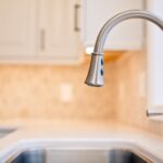 Kitchen remodel with white cabinets, custom wood range hood and hexagon tile backsplash