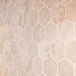 Kitchen remodel with white cabinets, custom wood range hood and hexagon tile backsplash