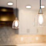 Kitchen remodel with white cabinets, custom wood range hood and hexagon tile backsplash