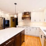 Kitchen remodel with white cabinets, custom wood range hood and hexagon tile backsplash