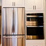 Kitchen remodel with white cabinets, custom wood range hood and hexagon tile backsplash