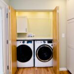 White modern kitchen remodel in Onondaga NY with bright cabinetry and light countertops