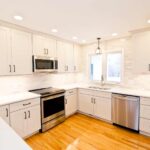 White modern kitchen remodel in Onondaga NY with bright cabinetry and light countertops