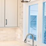 White modern kitchen remodel in Onondaga NY with bright cabinetry and light countertops