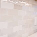 White modern kitchen remodel in Onondaga NY with bright cabinetry and light countertops