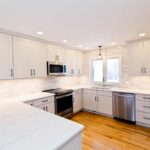 White modern kitchen remodel in Onondaga NY with bright cabinetry and light countertops