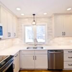 White modern kitchen remodel in Onondaga NY with bright cabinetry and light countertops