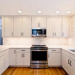 White modern kitchen remodel in Onondaga NY with bright cabinetry and light countertops