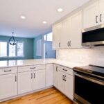 White modern kitchen remodel in Onondaga NY with bright cabinetry and light countertops