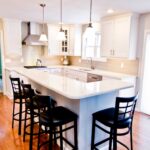 Kitchen remodel with white cabinets, large island and open layout