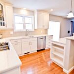 Kitchen remodel with white cabinets, large island and open layout